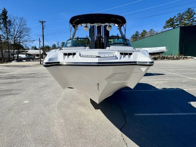 Slide: The Image of 2022 MasterCraft XStar boat in a parking lot, front view, clear blue sky. - 4