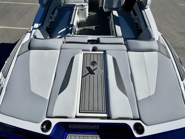 Slide: The Image of 2022 MasterCraft XStar boat interior with sleek gray seating and stylish design. - 9