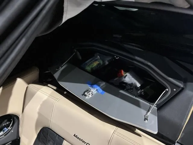 Slide: The Image of 2024 MasterCraft X24 boat interior storage compartment with open lid. - 11