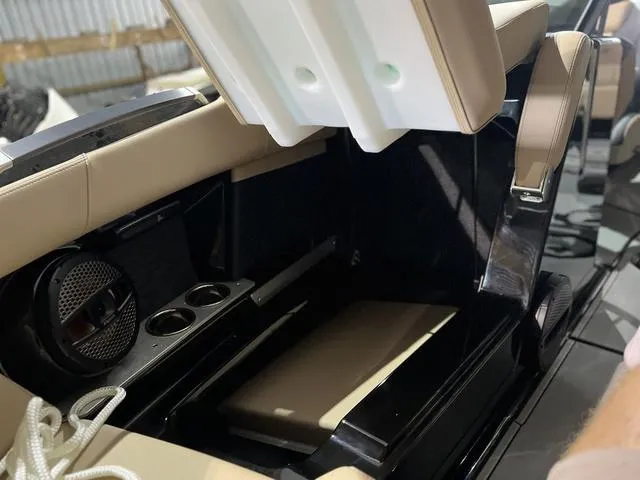 Slide: The Image of 2024 MasterCraft X24 boat interior with storage compartment and cup holders. - 14