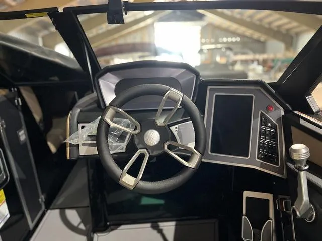 Slide: The Image of 2024 MasterCraft X24 boat dashboard with steering wheel and digital display. - 6