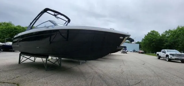 Slide: The Image of 2024 Cobalt R8 boat on display in a parking lot with overcast sky. - 1