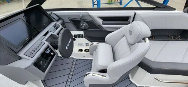 Slide: The Image of 2024 Cobalt R8 boat interior with modern dashboard and luxurious seating. - 11