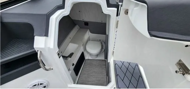Slide: The Image of 2024 Cobalt R8 boat interior with compact bathroom and modern design. - 7