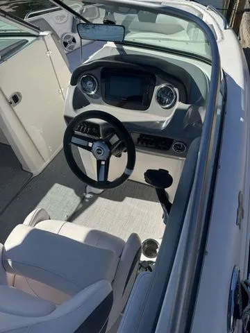 Slide: The Image of 2019 Chaparral 23 H2O Sport boat interior with steering wheel and dashboard. - 4