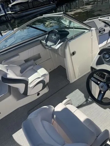 Slide: The Image of 2019 Chaparral 23 H2O Sport boat interior with steering wheel and seating. - 5