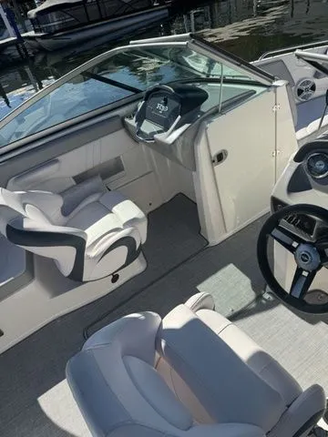 Slide: The Image of 2019 Chaparral 23 H2O Sport boat interior with steering wheel and seating. - 6