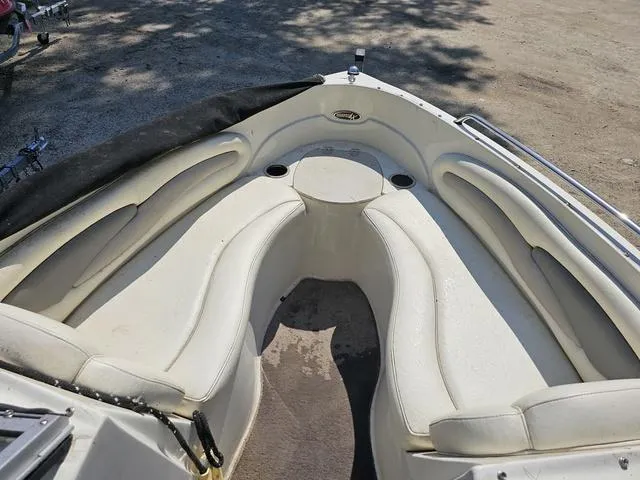 Slide: The Image of 2011 Stingray 195 LX boat interior with white cushioned seating and cup holders. - 9