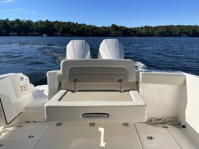 Slide: The Image of 2024 Boston Whaler 280 Vantage boat with dual engines on a serene lake. - 15