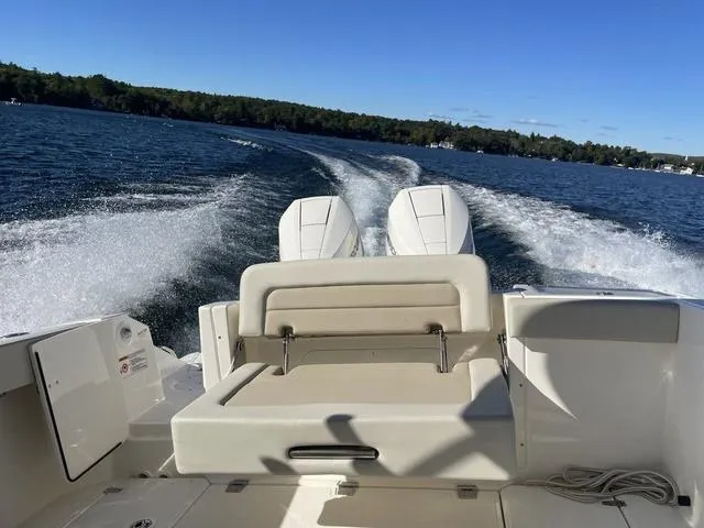 Slide: The Image of 2024 Boston Whaler 280 Vantage cruising on a lake with twin engines. - 16