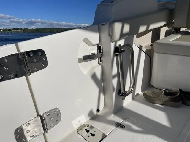 Slide: The Image of 2024 Boston Whaler 280 Vantage interior, featuring stainless steel hardware and seating. - 19