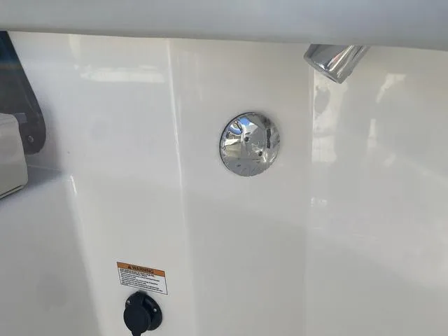 Slide: The Image of 2024 Boston Whaler 280 Vantage boat detail, featuring a sleek white surface and metal fixtures. - 23