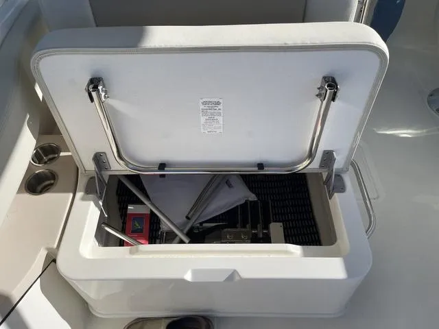 Slide: The Image of Open storage compartment on 2024 Boston Whaler 280 Vantage boat, showing interior contents. - 24