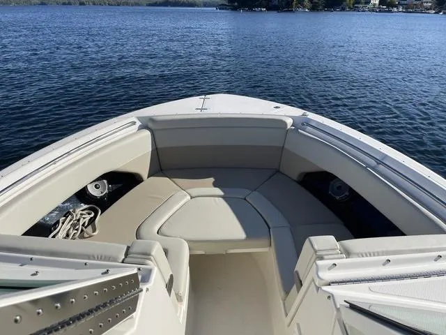 Slide: The Image of 2024 Boston Whaler 280 Vantage boat interior with seating, on a calm lake. - 32
