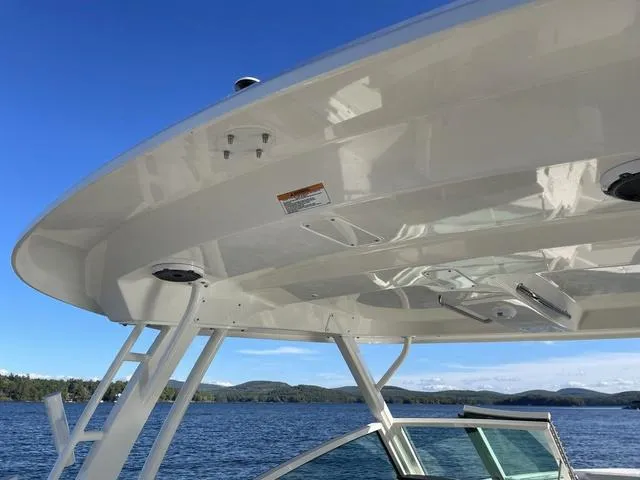 Slide: The Image of 2024 Boston Whaler 280 Vantage boat on a lake with clear blue sky. - 39