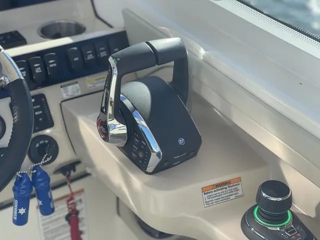 Slide: The Image of 2024 Boston Whaler 280 Vantage helm controls with throttle and joystick. - 40