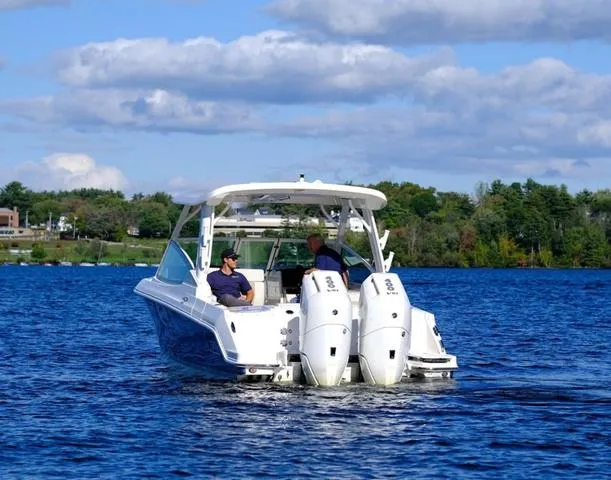 Slide: The Image of 2024 Boston Whaler 280 Vantage boat cruising on a lake under a partly cloudy sky. - 5