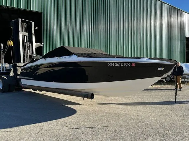 Slide: The Image of 2022 Cobalt R4 boat on forklift near green warehouse. - 1