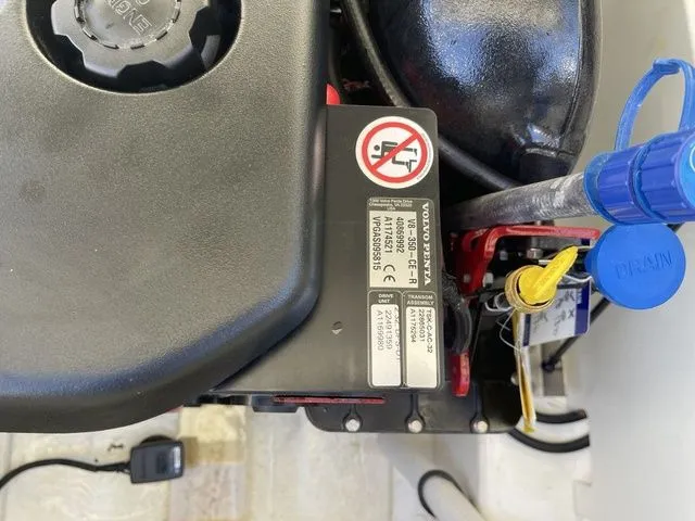 Slide: The Image of Engine compartment of a 2022 Cobalt R4 with visible warning labels and components. - 11