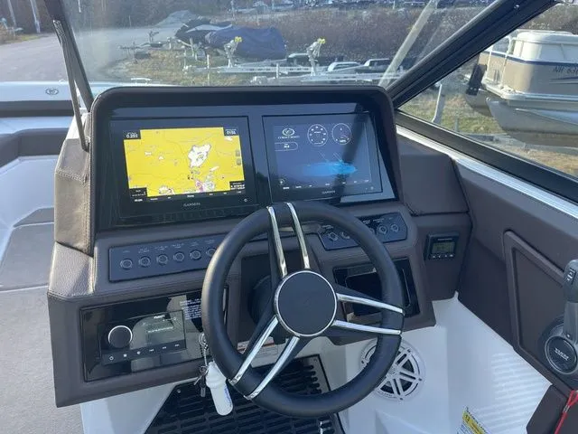 Slide: The Image of 2022 Cobalt R4 boat dashboard with navigation screens and steering wheel. - 12