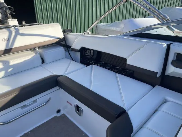 Slide: The Image of 2022 Cobalt R4 boat interior with white seating and cup holders. - 17