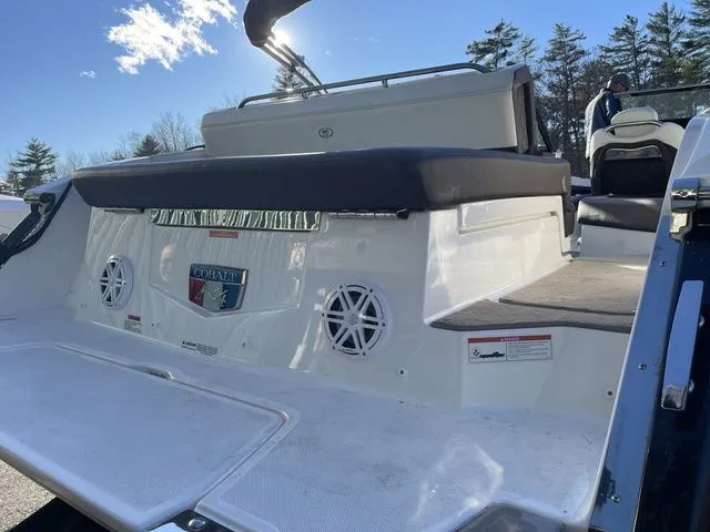 Slide: The Image of 2022 Cobalt R4 boat rear view with speakers and seating, under clear blue sky. - 21