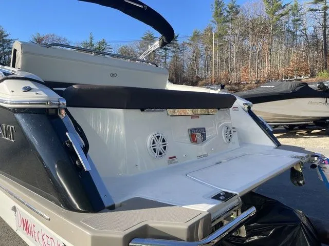 Slide: The Image of 2022 Cobalt R4 boat with swim platform and speakers, parked outdoors. - 22