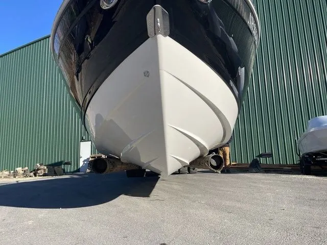 Slide: The Image of 2022 Cobalt R4 boat on dry dock, green warehouse background. - 5