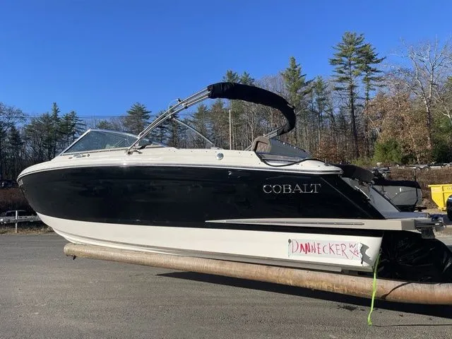 Slide: The Image of 2022 Cobalt R4 boat on trailer, black and white design, parked outdoors. - 6