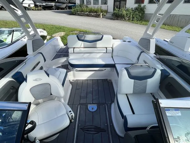 Slide: The Image of 2023 Chaparral 247 SSX boat interior with white and gray seating, modern design. - 11