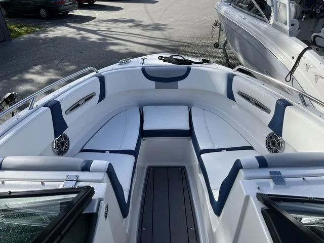 Slide: The Image of 2023 Chaparral 247 SSX boat interior with white and blue seating. - 13