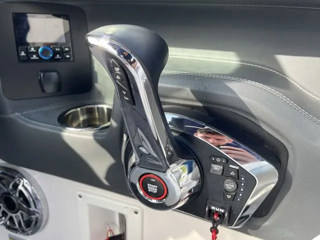 Slide: The Image of 2023 Chaparral 247 SSX boat throttle control with start/stop button and audio system. - 16