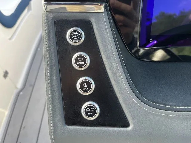 Slide: The Image of Control panel of 2023 Chaparral 247 SSX boat with various function buttons. - 20