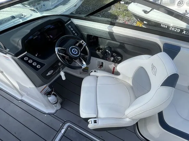 Slide: The Image of 2023 Chaparral 247 SSX boat interior with sleek dashboard and comfortable captain's chair. - 22