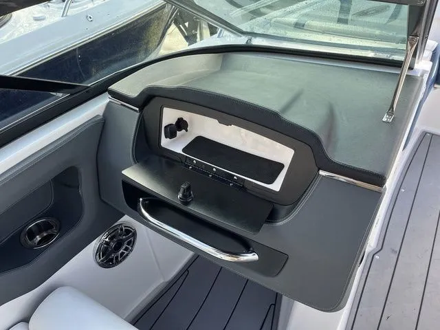 Slide: The Image of 2023 Chaparral 247 SSX boat dashboard with sleek design and modern controls. - 23