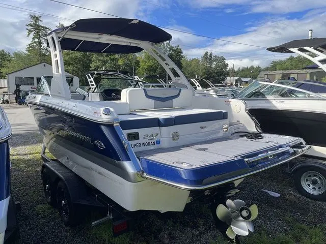Slide: The Image of 2023 Chaparral 247 SSX boat with blue and white design on a trailer. - 4