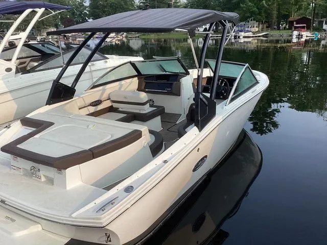 Slide: The Image of 2024 Cobalt CS22 boat docked on calm water, featuring sleek design and spacious seating. - 1