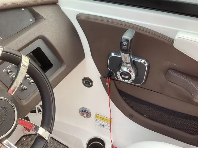 Slide: The Image of 2024 Cobalt CS22 boat interior, featuring steering wheel and throttle controls. - 4