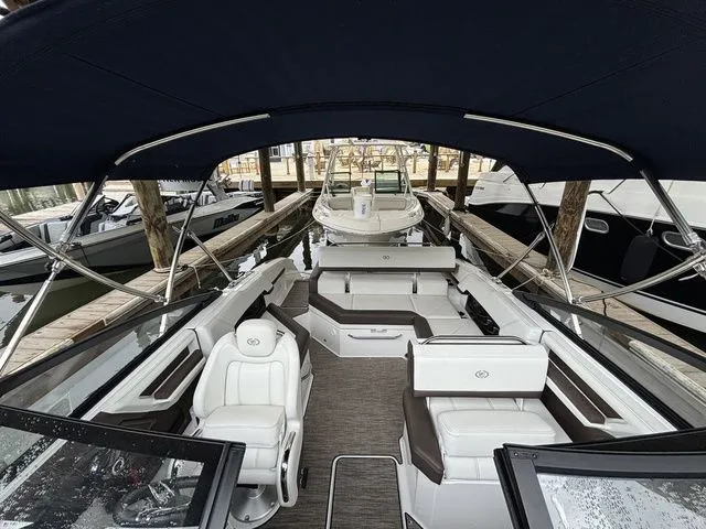 Slide: The Image of 2024 Cobalt R4 boat with sleek interior design docked at a marina. - 11