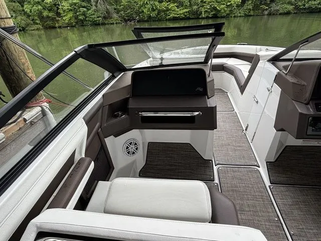 Slide: The Image of 2024 Cobalt R4 boat interior with sleek seating and modern design on a calm river. - 6