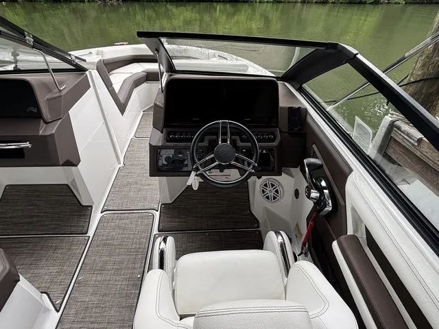 Slide: The Image of 2024 Cobalt R4 boat interior with modern dashboard and steering wheel, featuring sleek seating. - 7
