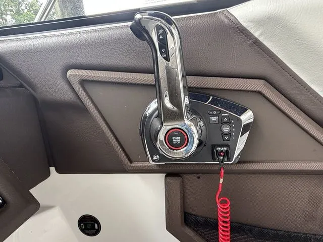 Slide: The Image of 2024 Cobalt R4 boat throttle control with start/stop button and safety lanyard. - 9