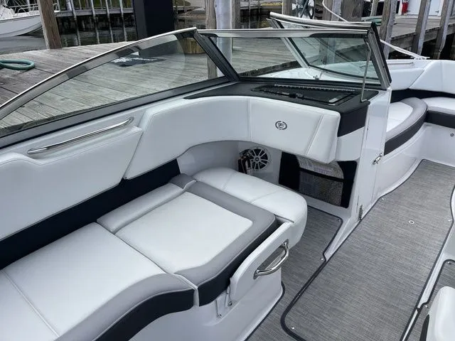 Slide: The Image of 2024 Cobalt 220S boat interior with white seating and sleek design. - 10