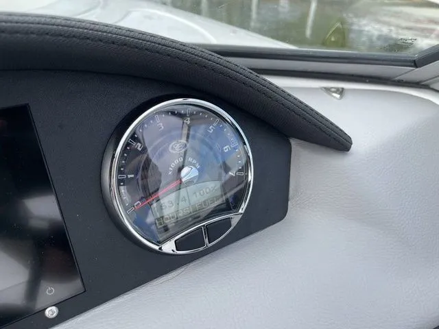 Slide: The Image of Dashboard of 2024 Cobalt 220S boat featuring speedometer and digital display. - 12