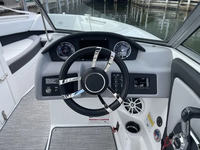 Slide: The Image of 2024 Cobalt 220S boat dashboard with steering wheel and control panel. - 13