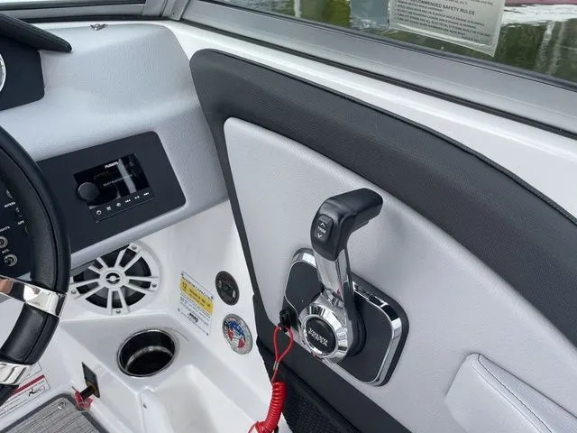 Slide: The Image of 2024 Cobalt 220S boat interior with control panel and throttle lever. - 14