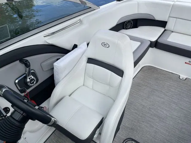 Slide: The Image of 2024 Cobalt 220S boat interior with white seating and modern steering controls. - 16