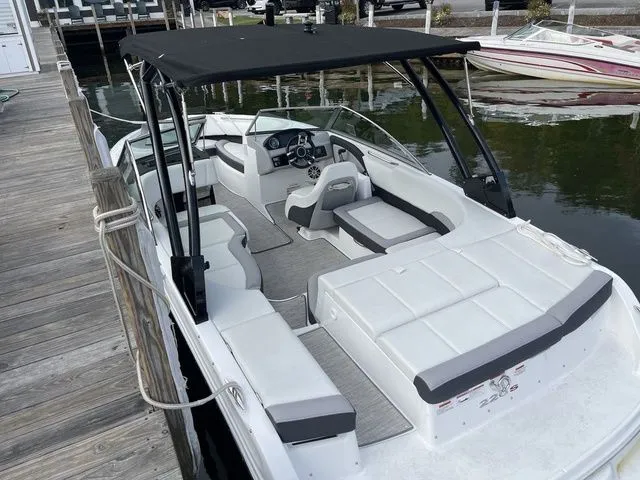 Slide: The Image of 2024 Cobalt 220S boat with sleek white interior docked at a marina. - 20