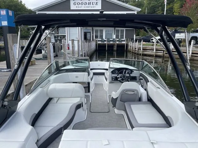 Slide: The Image of 2024 Cobalt 220S boat interior at dock, featuring sleek white seating and modern design. - 4