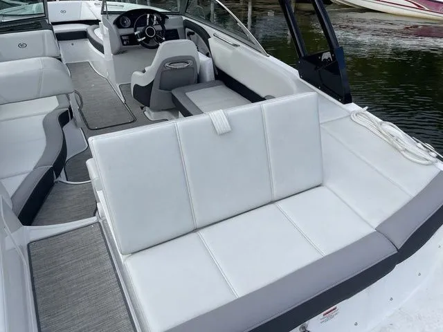 Slide: The Image of 2024 Cobalt 220S boat interior with white seating and modern dashboard design. - 5